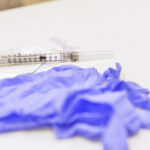 COVID-19 vaccines and gloves
